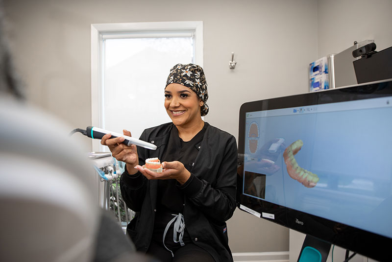 Team member taking a 3d scan of model of dentla implant