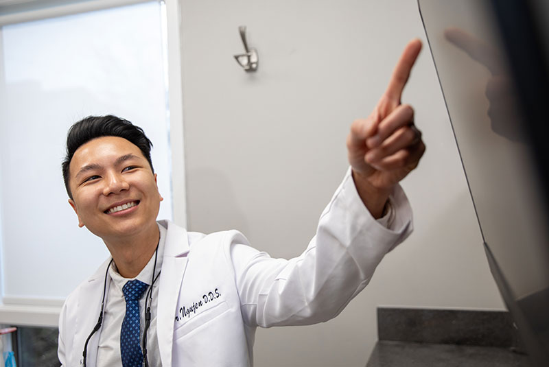 Doctor pointing at dental x-rays