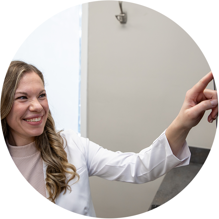 Doctor Pointing at x-rays of Patients teeth