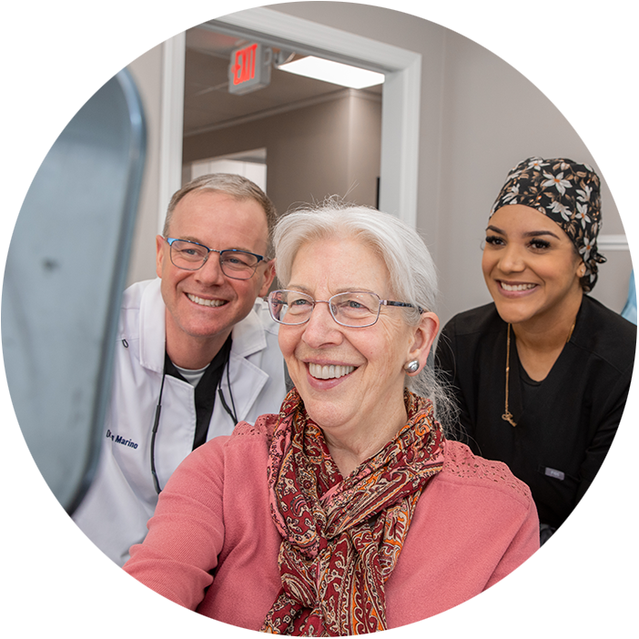 Patient and doctor looking into mirror